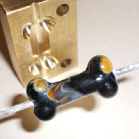 A bone bead, made in the Bone Press